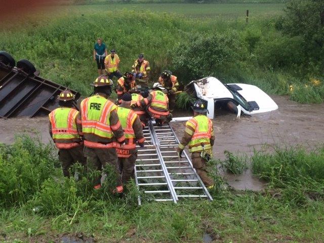 Firefighter assisting a semi in a ditch